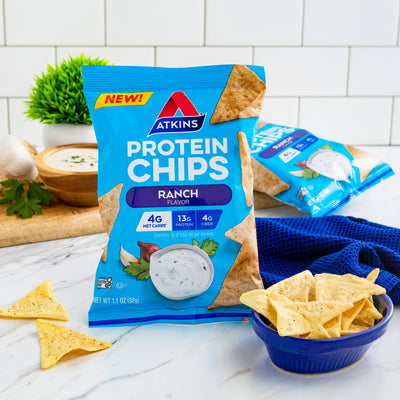 Ranch Snack Protein Chips with ranch dressing, chopping board, blue cloth on marble table