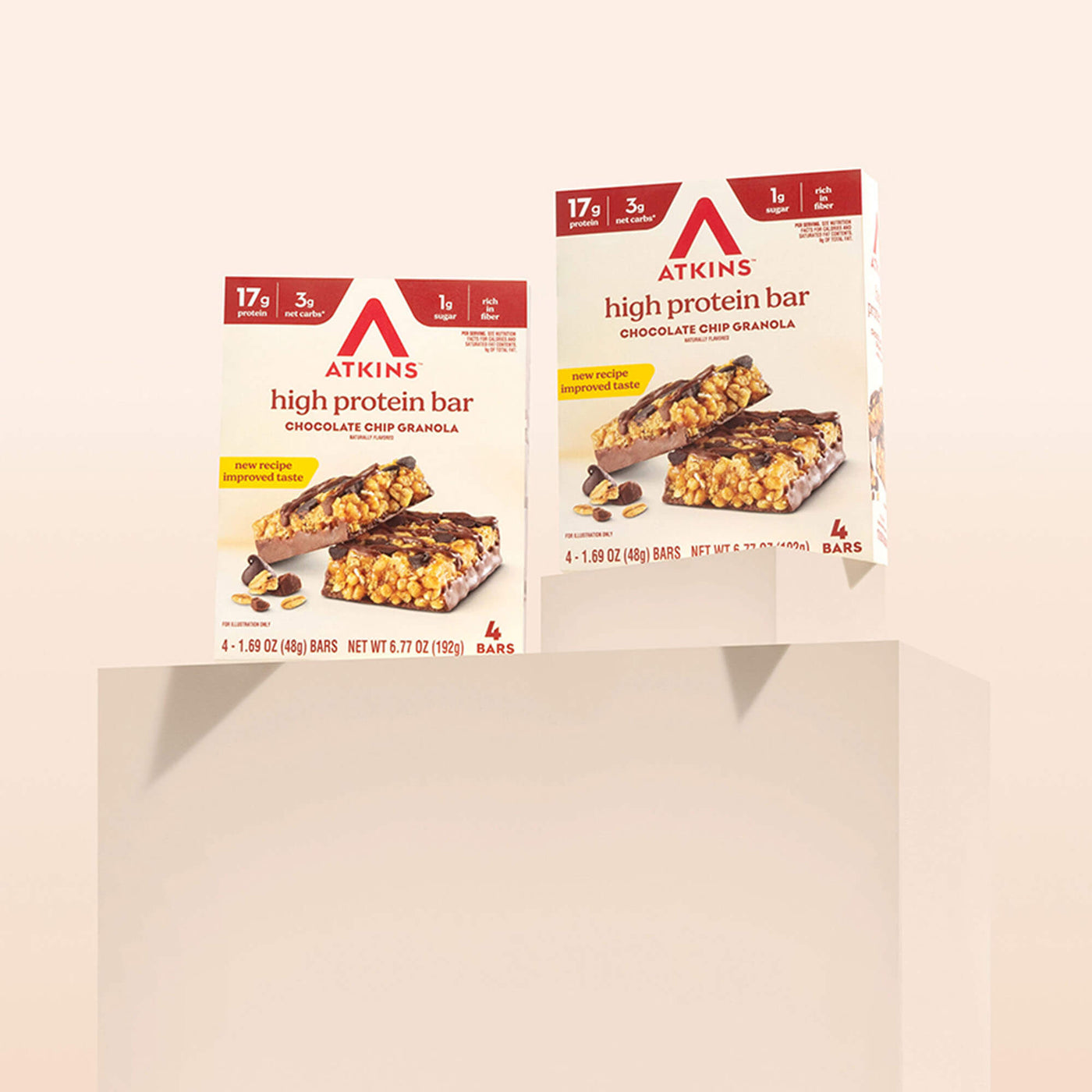 Two boxes of Atkins high protein bars on a beige background