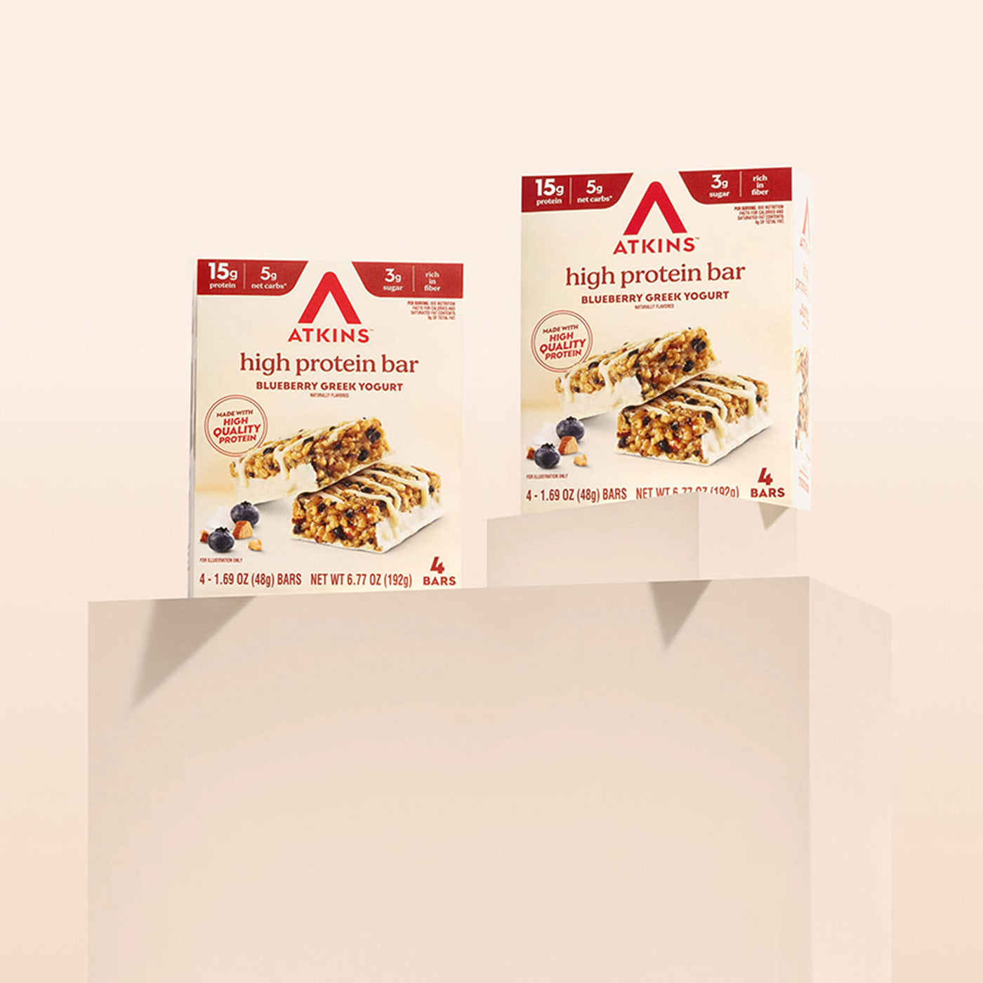 Two boxes of Atkins high protein bars on a beige background