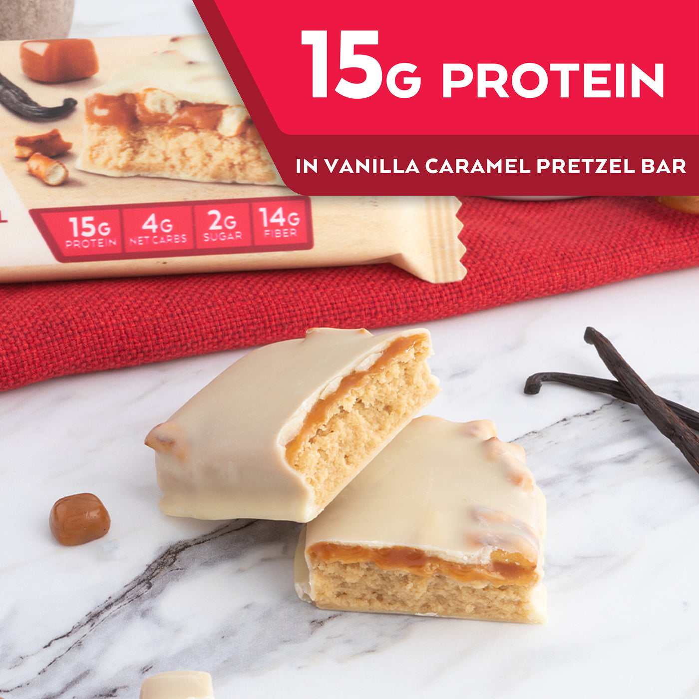Vanilla Caramel Pretzel Bar with vanilla bean, caramel and red cloth on marble table; 15G Protein in vanilla caramel pretzel bar