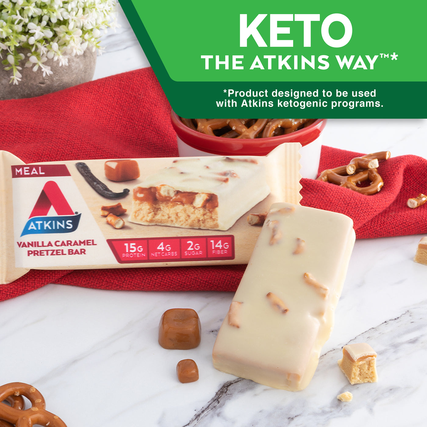 Vanilla Caramel Pretzel Bar with vanilla bean, caramel and red cloth on marble table; Keto The Atkins Way* *Product designed to be used with Atkins ketogenic programs.