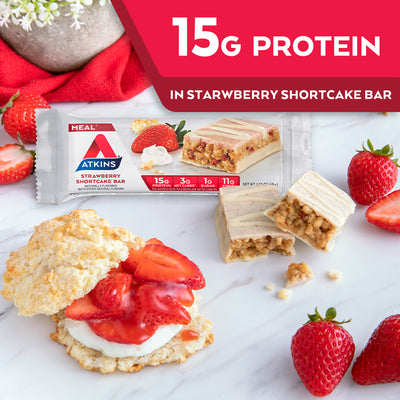 Strawberry Shortcake Bar with strawberries, shortcake and red cloth on marble table; 15G Protein in Strawberry shortcake bar