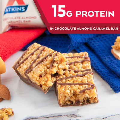 Chocolate Almond Caramel Bar with almond and blue cloth on marble table; 15G Protein in Chocolate almond caramel bar