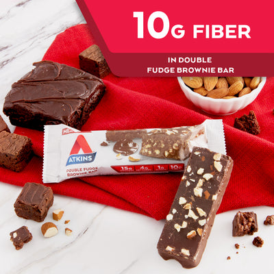 Double Fudge Brownie Bar with almond and chocolate next to it on a marble table; 10G Fiber in Double fudge brownie bar