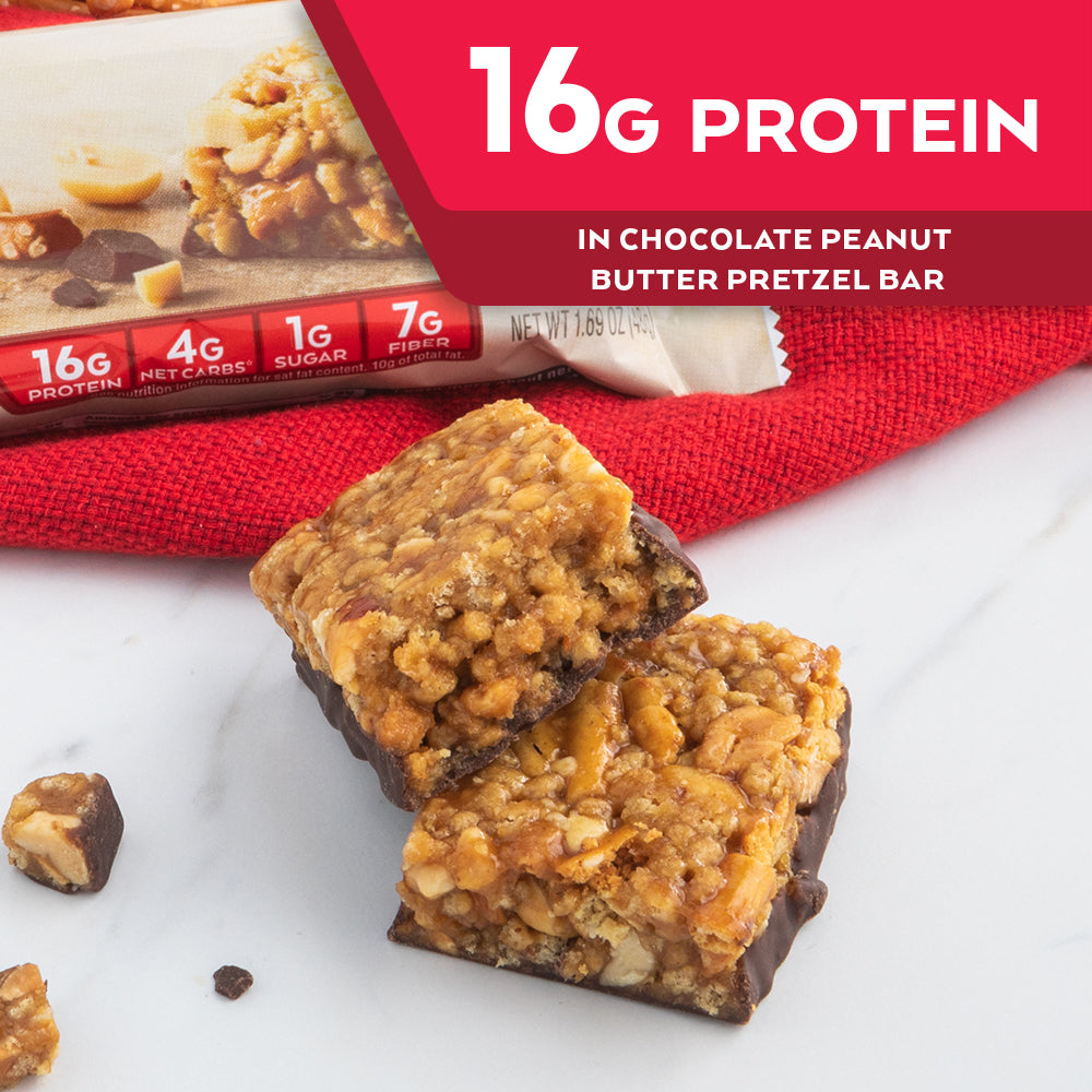 Chocolate Peanut Butter Pretzel Bar with red cloth on marble table; 16G Protein in vanilla caramel pretzel bar