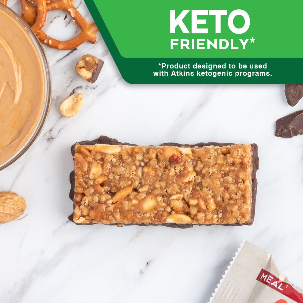 Chocolate Peanut Butter Pretzel Bar with pretzel and peanut butter, red cloth on marble table; Keto The Atkins Way* *Product designed to be used with Atkins ketogenic programs.