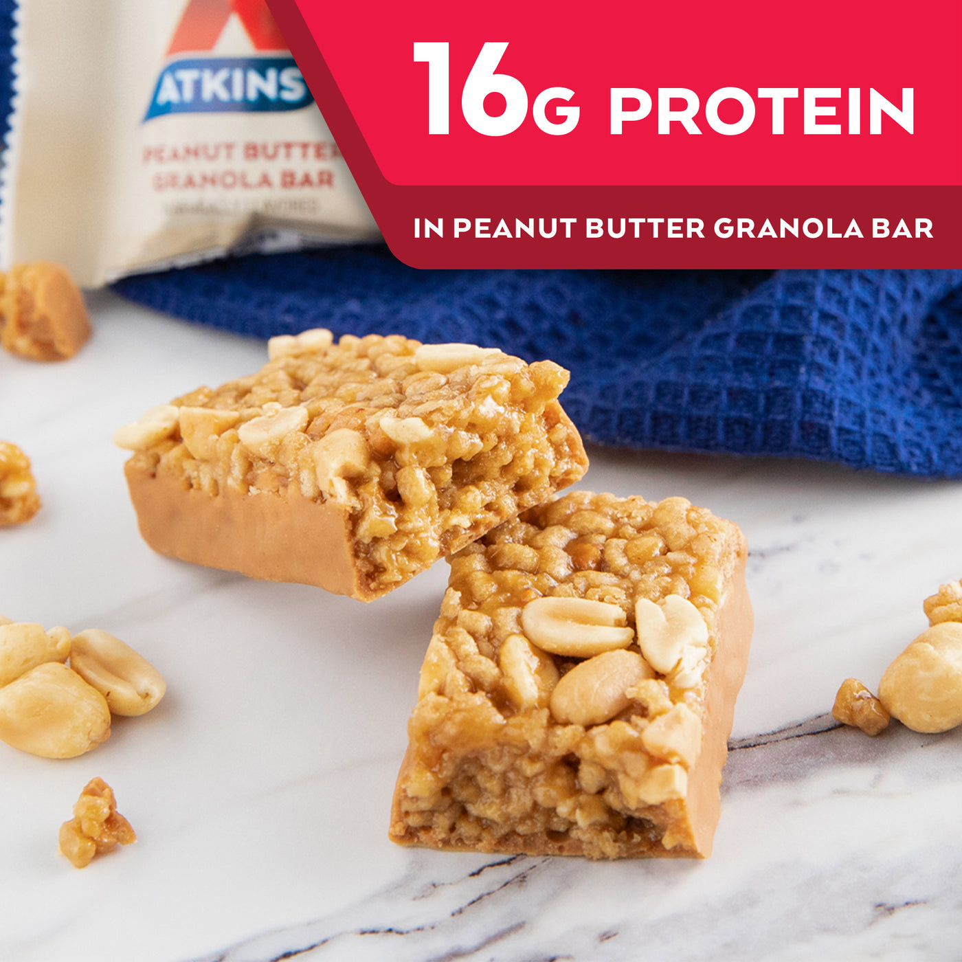 Peanut Butter Granola Bar with peanuts and blue cloth on marble table; 16G Protein in Peanut Butter Granola Bar