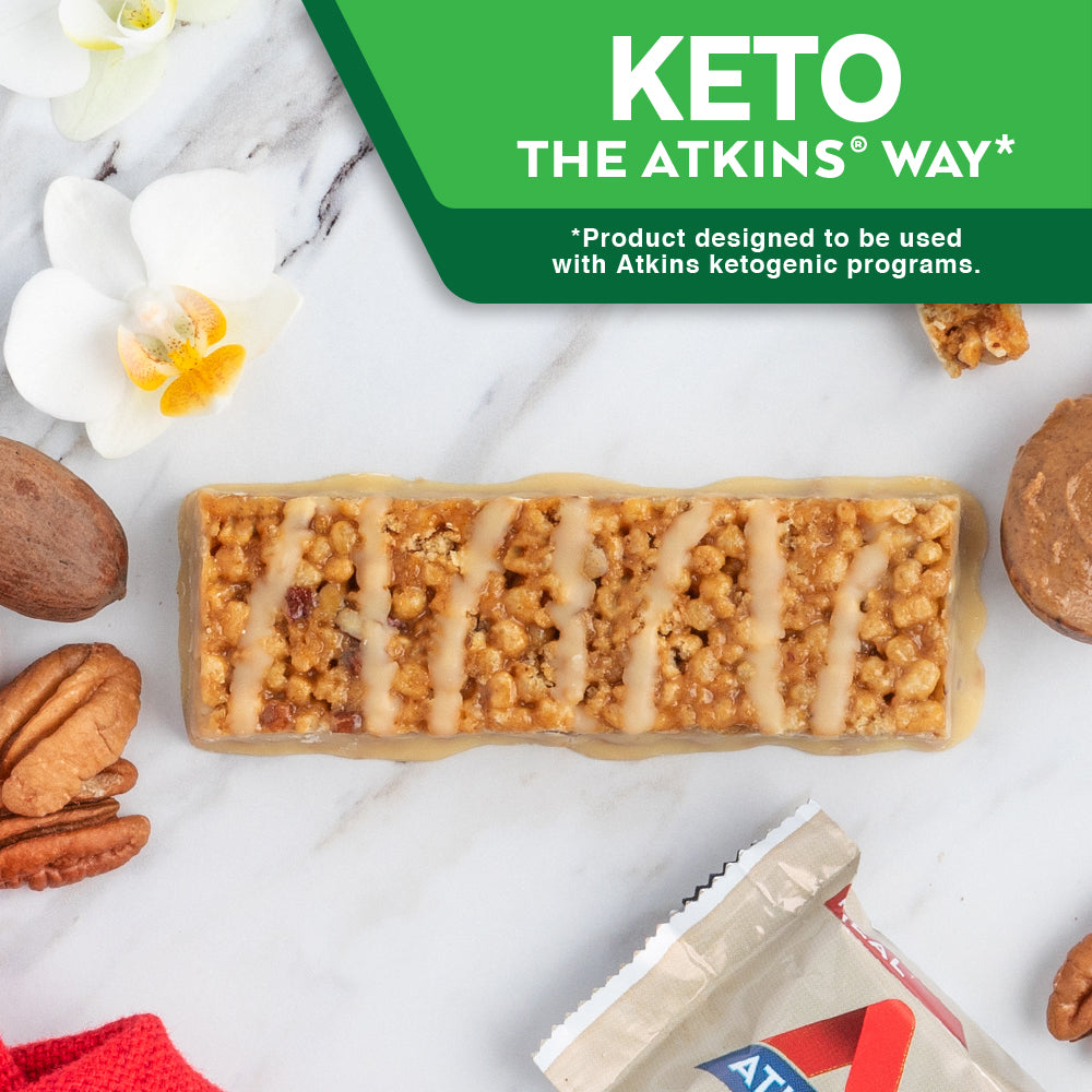 Vanilla Pecan Crisp Bar with peanut butter, walnut and red cloth on marble table; Keto The Atkins Way* *Product designed to be used with Atkins ketogenic programs.
